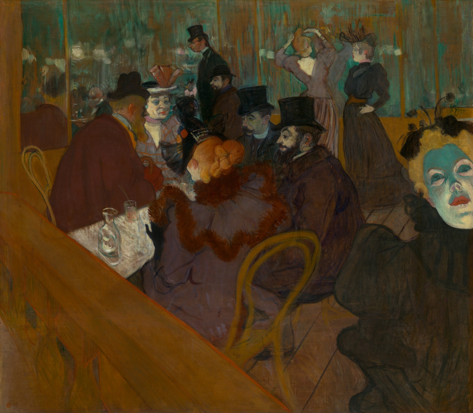 A crowded evening table in green lamplight