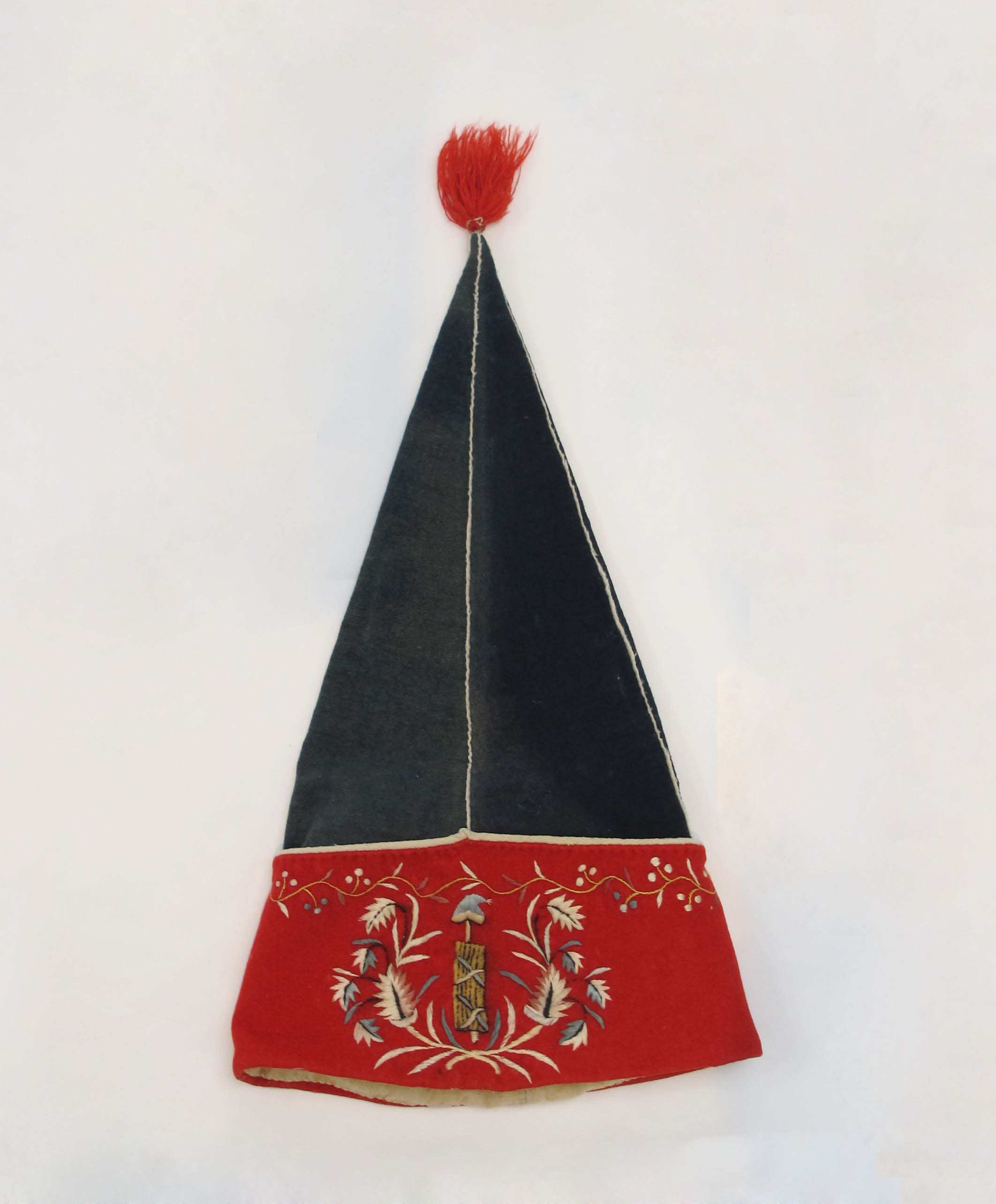 An embroidered cap held as a museum object